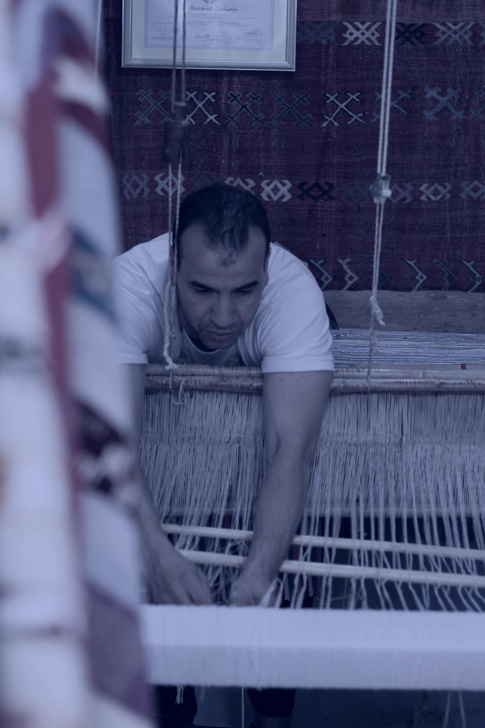Rachid Chliah working at his traditional wooden loom in the Antique Chaouen workshop, Chefchaouen